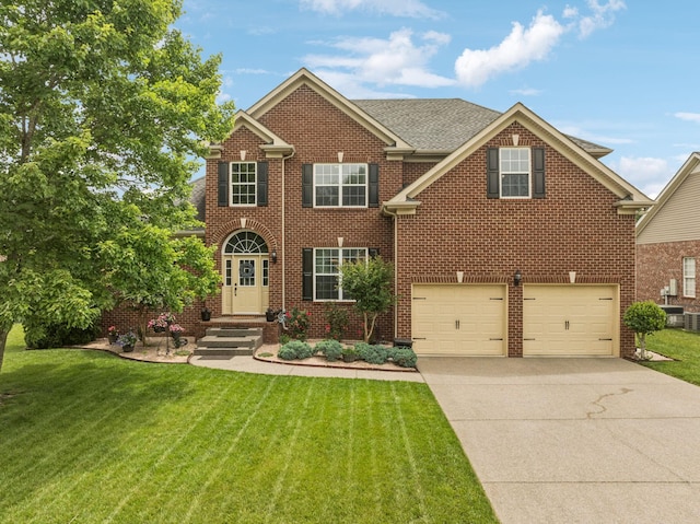 1011 Brixworth Dr, Thompsons Station, TN 37179 - view of front of house featuring concrete driveway, a garage, a front yard, and brick siding