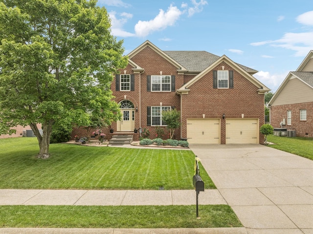 1011 Brixworth Dr, Thompsons Station, TN 37179 - view of front facade featuring concrete driveway, a garage, brick siding, and a front yard