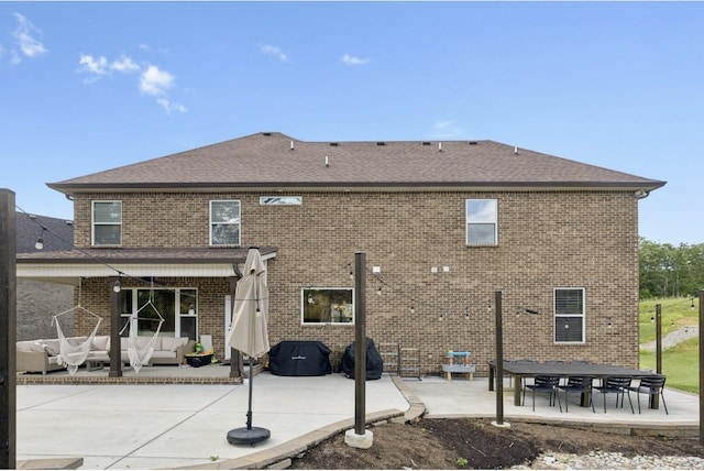 718 Excalibur Ct, Smyrna, TN 37167 - back of property featuring outdoor lounge area, a patio area, brick siding, and roof with shingles