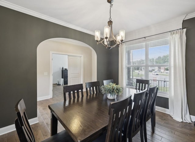 718 Excalibur Ct, Smyrna, TN 37167 - dining space featuring arched walkways, a chandelier, crown molding, and hardwood / wood-style flooring
