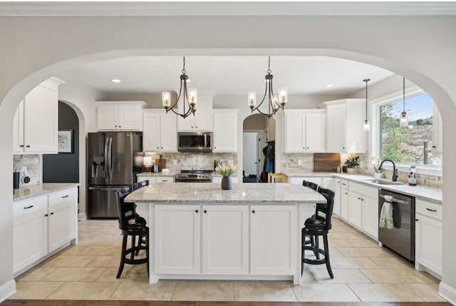 718 Excalibur Ct, Smyrna, TN 37167 - kitchen with stainless steel appliances, tasteful backsplash, a breakfast bar, a center island, and recessed lighting