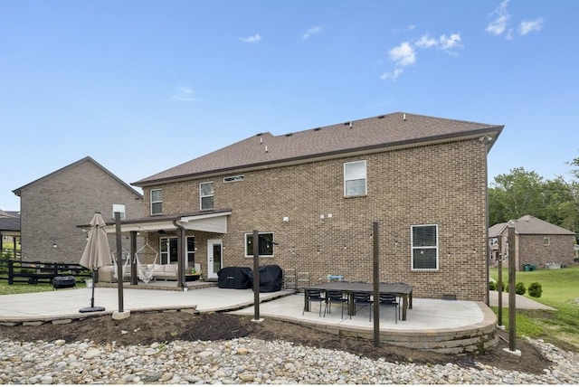 718 Excalibur Ct, Smyrna, TN 37167 - back of house featuring a patio, brick siding, and an outdoor living space