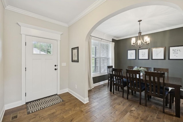 718 Excalibur Ct, Smyrna, TN 37167 - entrance foyer with dark wood-style flooring, arched walkways, a chandelier, and ornamental molding