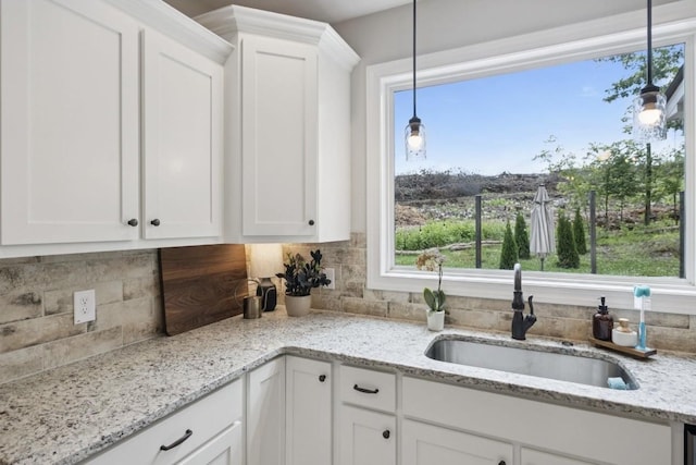 718 Excalibur Ct, Smyrna, TN 37167 - kitchen with white cabinets, decorative backsplash, hanging light fixtures, and light stone countertops