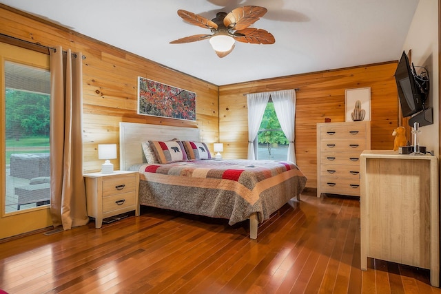 3121 Coon Hunter Lodge Rd, Jamestown, TN 38556 - bedroom featuring wood walls, dark wood-style floors, and a ceiling fan