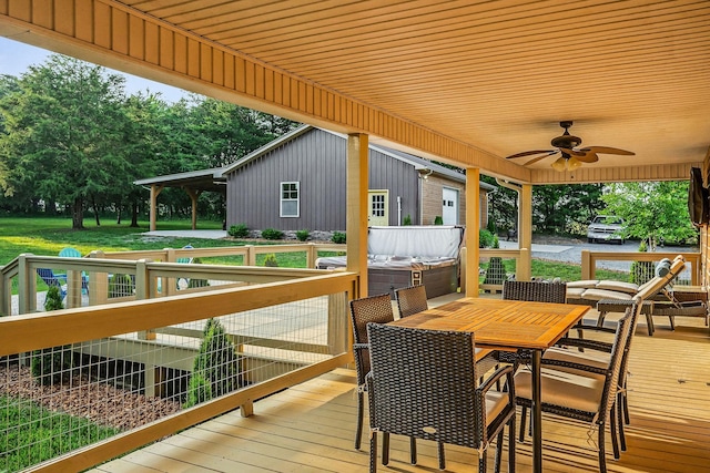 3121 Coon Hunter Lodge Rd, Jamestown, TN 38556 - deck featuring ceiling fan, outdoor dining area, a lawn, and view of scattered trees