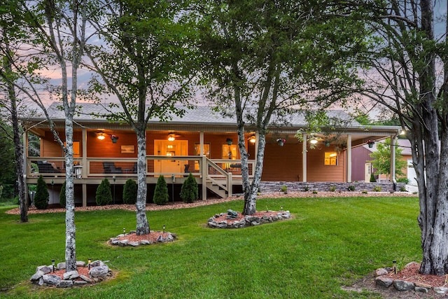 3121 Coon Hunter Lodge Rd, Jamestown, TN 38556 - back of house at dusk with a yard and covered porch