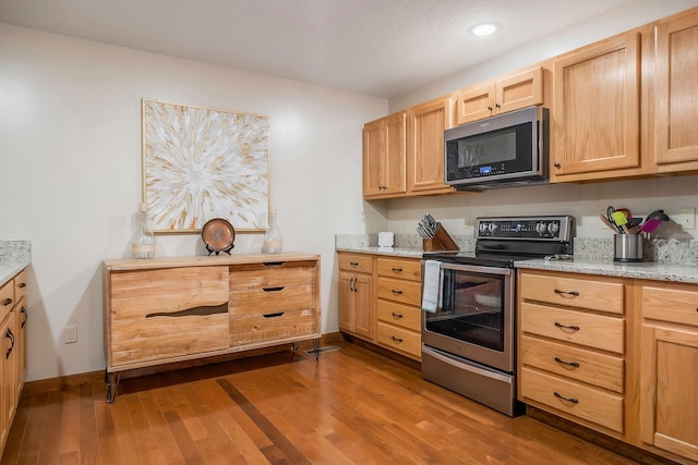 3121 Coon Hunter Lodge Rd, Jamestown, TN 38556 - kitchen with stainless steel electric range, dark wood finished floors, light brown cabinets, recessed lighting, and light stone countertops