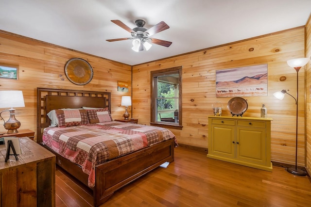 3121 Coon Hunter Lodge Rd, Jamestown, TN 38556 - bedroom with wooden walls, wood finished floors, and ceiling fan