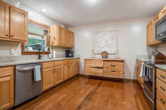 3121 Coon Hunter Lodge Rd, Jamestown, TN 38556 - kitchen with appliances with stainless steel finishes, dark wood-type flooring, recessed lighting, and light stone countertops
