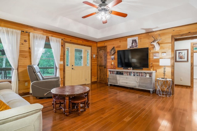 3121 Coon Hunter Lodge Rd, Jamestown, TN 38556 - living room featuring wooden walls, wood finished floors, ceiling fan, healthy amount of natural light, and a tray ceiling
