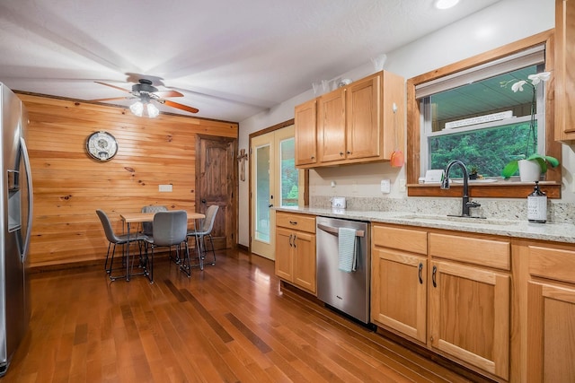 3121 Coon Hunter Lodge Rd, Jamestown, TN 38556 - kitchen with stainless steel appliances, ceiling fan, dark wood-style floors, wooden walls, and light stone countertops