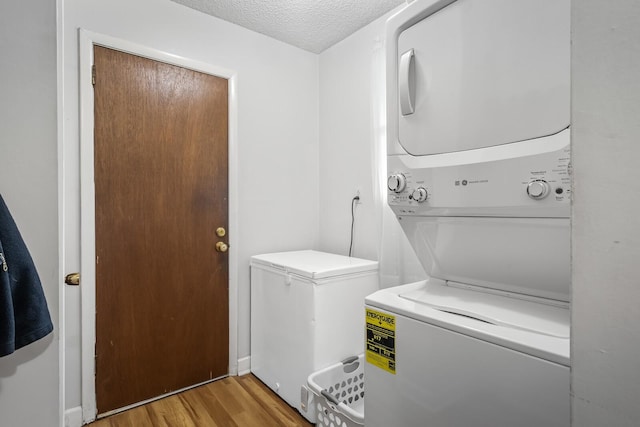 104 Chapman Dr, Lebanon, TN 37087 - laundry area with stacked washing machine and dryer, light wood-type flooring, and a textured ceiling