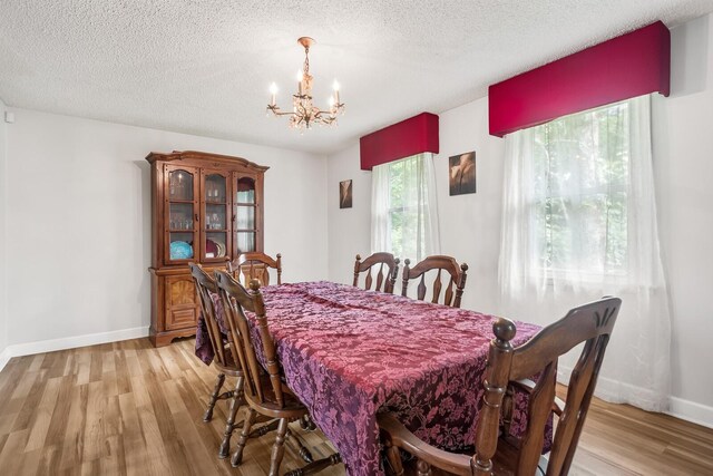104 Chapman Dr, Lebanon, TN 37087 - dining room featuring a chandelier, light wood finished floors, and a textured ceiling