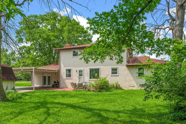 104 Chapman Dr, Lebanon, TN 37087 - rear view of house featuring french doors, stucco siding, a lawn, a patio, and a chimney