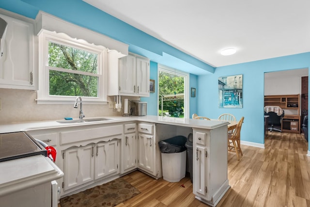 104 Chapman Dr, Lebanon, TN 37087 - kitchen with white cabinets, light wood finished floors, a peninsula, and light countertops