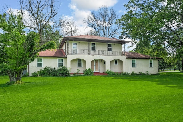 104 Chapman Dr, Lebanon, TN 37087 - view of front facade with a balcony, stucco siding, and a front lawn