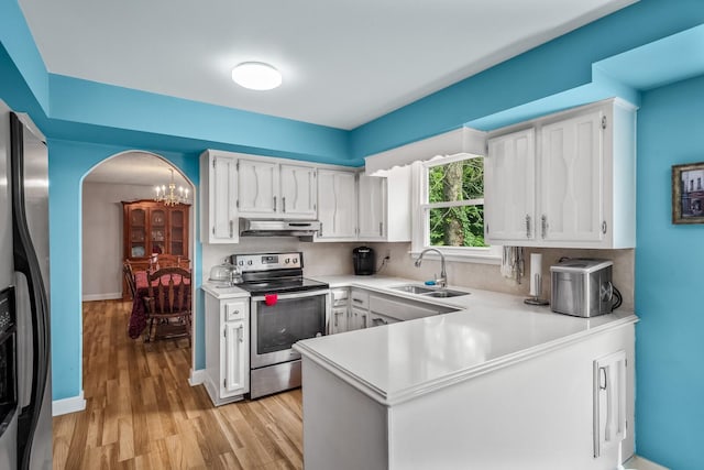 104 Chapman Dr, Lebanon, TN 37087 - kitchen with appliances with stainless steel finishes, under cabinet range hood, light countertops, and white cabinetry
