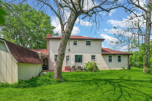 104 Chapman Dr, Lebanon, TN 37087 - rear view of house with stucco siding, a lawn, a patio, entry steps, and a chimney