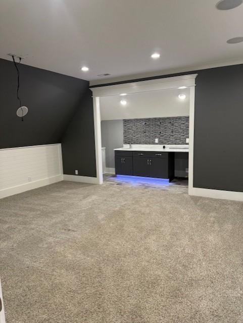 1430 Avellino Cir, Murfreesboro, TN 37130 - unfurnished living room featuring light colored carpet, bar, vaulted ceiling, and recessed lighting