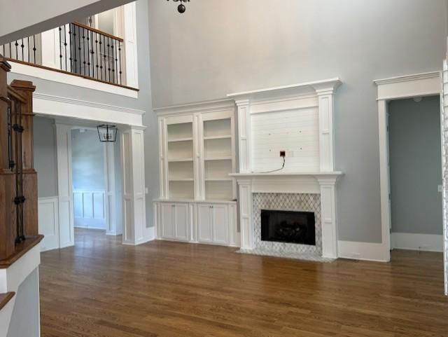 1430 Avellino Cir, Murfreesboro, TN 37130 - unfurnished living room with a high ceiling, wood finished floors, and a fireplace