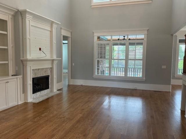 1430 Avellino Cir, Murfreesboro, TN 37130 - unfurnished living room featuring a high ceiling, a high end fireplace, and dark wood-style flooring