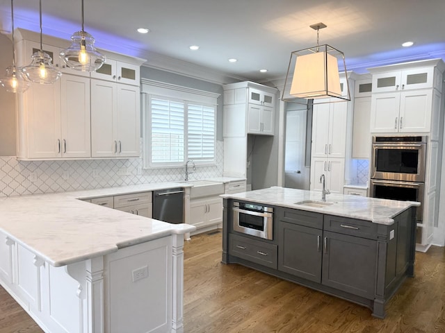 1430 Avellino Cir, Murfreesboro, TN 37130 - kitchen featuring white cabinets, appliances with stainless steel finishes, a peninsula, dark wood-style flooring, and ornamental molding