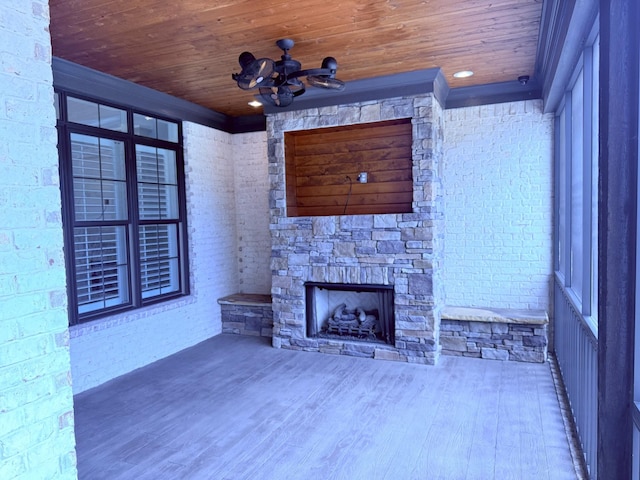 1430 Avellino Cir, Murfreesboro, TN 37130 - unfurnished living room featuring wood finished floors, wooden ceiling, an outdoor stone fireplace, brick wall, and ceiling fan