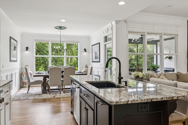 967 Nashs Nook, Columbia, TN 38401 - kitchen with wood finished floors, ornamental molding, light stone counters, a chandelier, and an island with sink