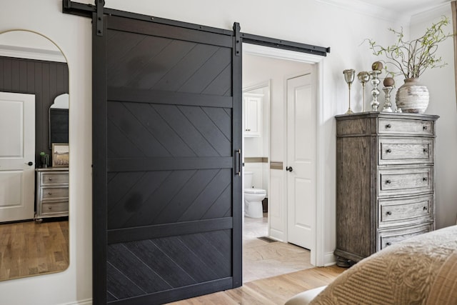 967 Nashs Nook, Columbia, TN 38401 - bedroom with a barn door, light wood-type flooring, crown molding, and connected bathroom