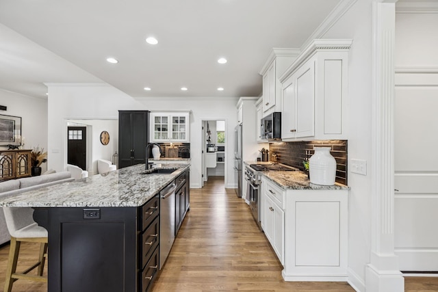 967 Nashs Nook, Columbia, TN 38401 - kitchen featuring premium appliances, white cabinets, a large island with sink, crown molding, and recessed lighting
