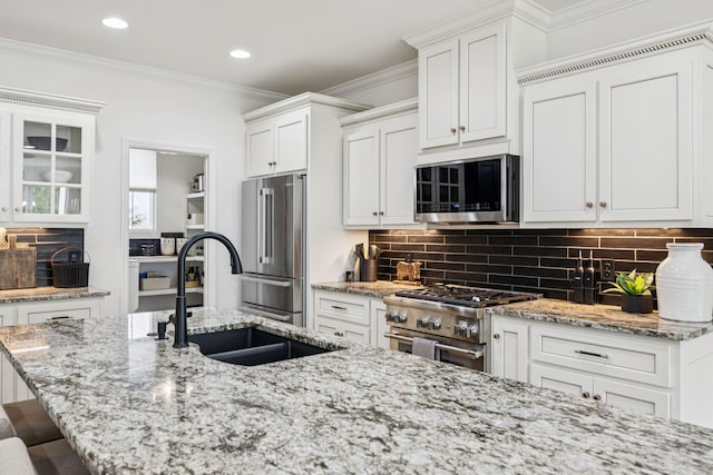 967 Nashs Nook, Columbia, TN 38401 - kitchen with high end appliances, tasteful backsplash, white cabinets, light stone counters, and a breakfast bar