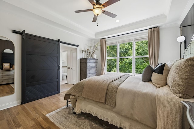 967 Nashs Nook, Columbia, TN 38401 - bedroom featuring a raised ceiling, a barn door, wood finished floors, ornamental molding, and ensuite bath