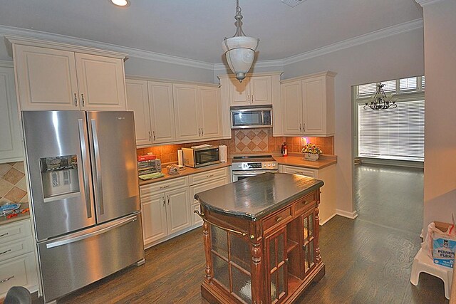 502 Johnstown Dr, Smyrna, TN 37167 - kitchen featuring appliances with stainless steel finishes, dark wood-type flooring, crown molding, decorative backsplash, and recessed lighting
