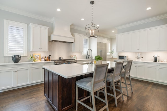 1014B Noelton Ave, Nashville, TN 37204 - kitchen with premium range hood, light countertops, recessed lighting, a center island with sink, and white cabinets