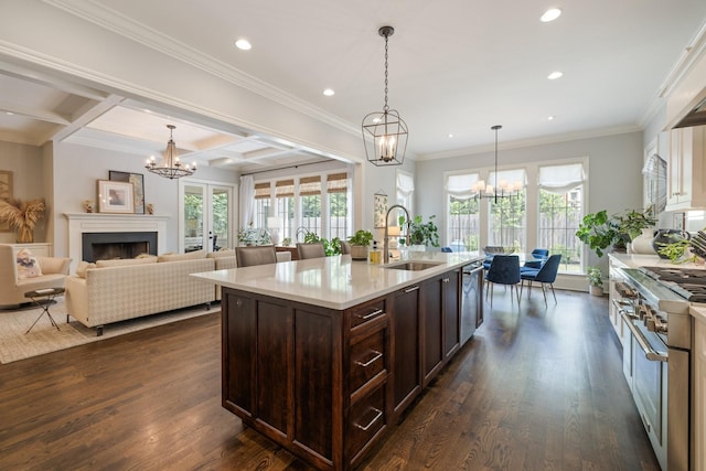 1014B Noelton Ave, Nashville, TN 37204 - kitchen featuring appliances with stainless steel finishes, a chandelier, dark brown cabinetry, recessed lighting, and a fireplace