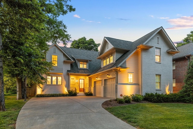 1014B Noelton Ave, Nashville, TN 37204 - view of front of house featuring brick siding, concrete driveway, a front yard, and an attached garage