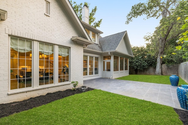 1014B Noelton Ave, Nashville, TN 37204 - rear view of property with a chimney, roof with shingles, a patio area, a sunroom, and brick siding