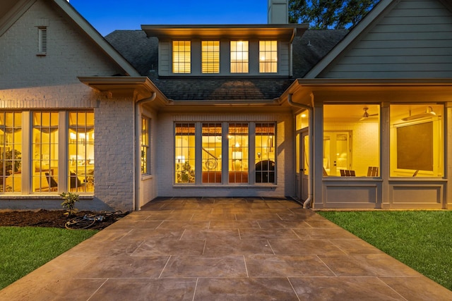 1014B Noelton Ave, Nashville, TN 37204 - back of property featuring a shingled roof, brick siding, a chimney, and a patio area