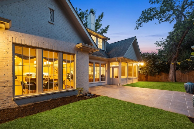 1014B Noelton Ave, Nashville, TN 37204 - back of property featuring a patio area, brick siding, a chimney, and a shingled roof