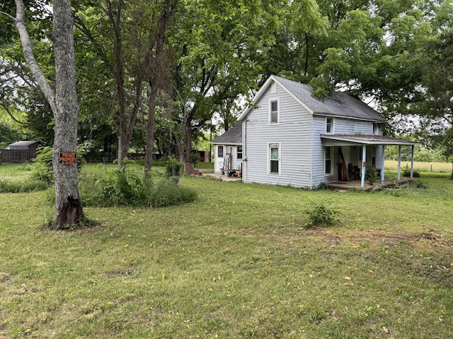 123 Butler Rd, Portland, TN 37148 - rear view of house with a yard and a shingled roof