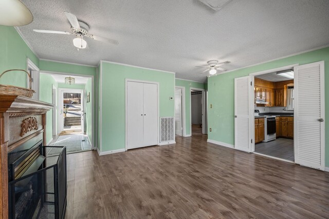 2220 Potts Camp Rd, Smithville, TN 37166 - unfurnished living room with a ceiling fan, wood finished floors, a textured ceiling, ornamental molding, and a fireplace