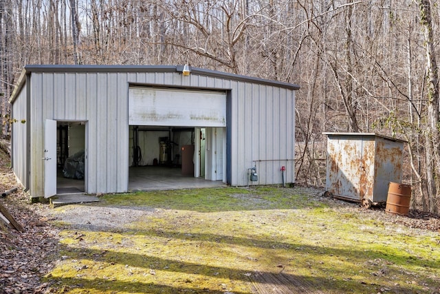 2220 Potts Camp Rd, Smithville, TN 37166 - garage with a wooded view and a storage unit