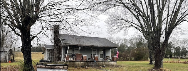 1007 Kennedy Creek Rd, Auburntown, TN 37016 - view of front facade featuring a porch, a front yard, and a chimney