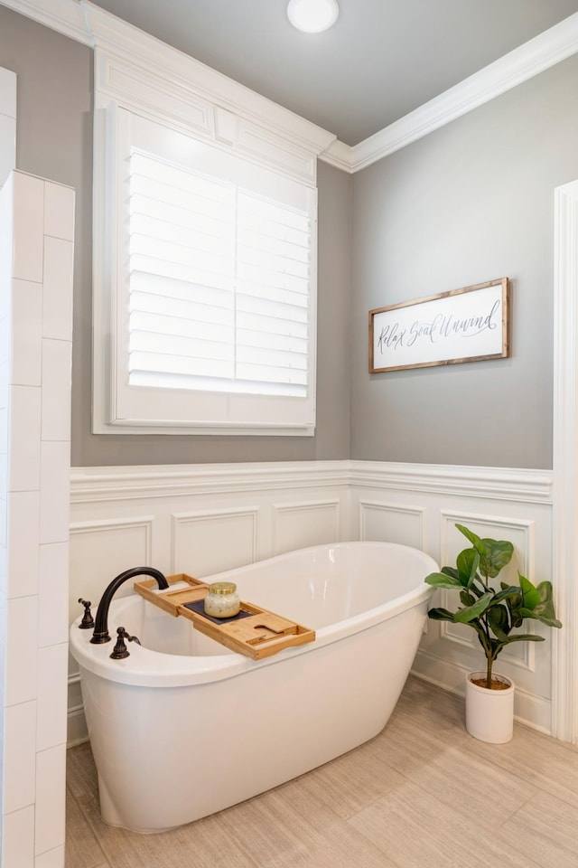 2003 Imagine Cir, Spring Hill, TN 37174 - bathroom with a decorative wall, a freestanding bath, crown molding, and wainscoting