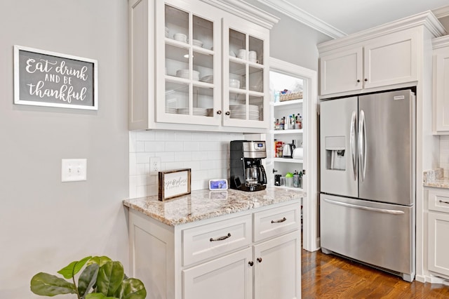 2003 Imagine Cir, Spring Hill, TN 37174 - kitchen featuring stainless steel fridge with ice dispenser, decorative backsplash, glass insert cabinets, white cabinets, and crown molding