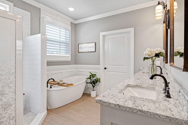 2003 Imagine Cir, Spring Hill, TN 37174 - bathroom featuring double vanity, ornamental molding, a soaking tub, tiled shower, and a wainscoted wall