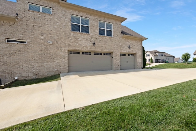 2003 Imagine Cir, Spring Hill, TN 37174 - view of side of home with a garage, brick siding, and concrete driveway