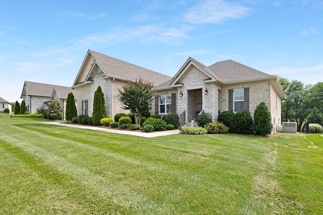 2003 Imagine Cir, Spring Hill, TN 37174 - view of front facade featuring a front lawn, stone siding, brick siding, and a shingled roof