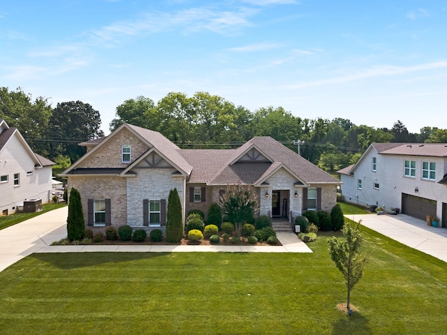 2003 Imagine Cir, Spring Hill, TN 37174 - view of front of property featuring stone siding, a front lawn, and concrete driveway